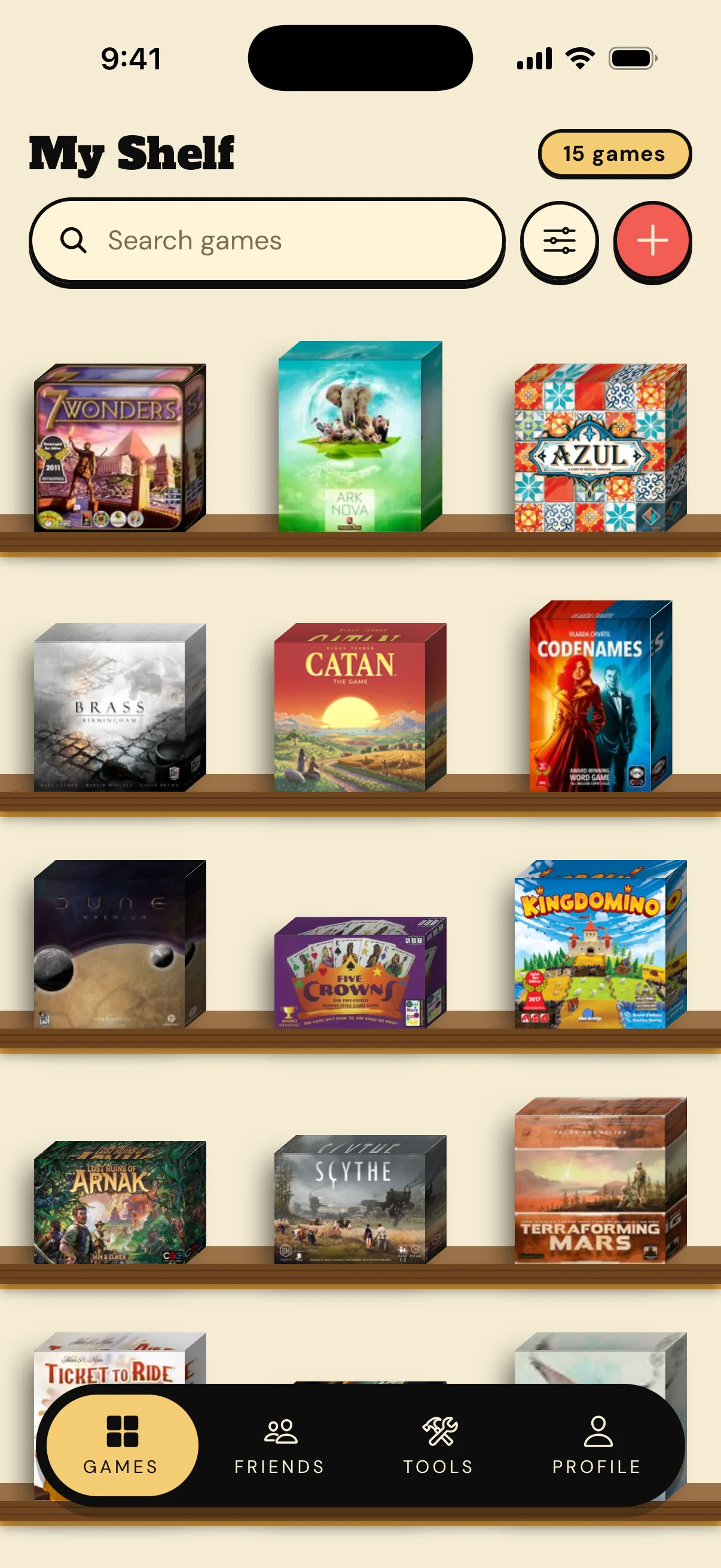 A board game collection lined up on wooden shelves